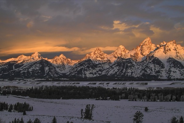 Snowy mountains over a lake